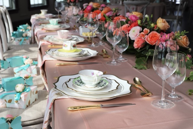 Blue table setting with tea sets and flowers