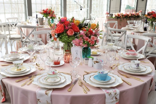 Pink table setting with tea sets and flowers