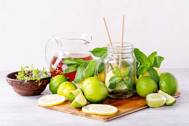 A pitcher with red juice, lime and mint leaves