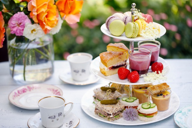 table set with tea cups, tea pot and food